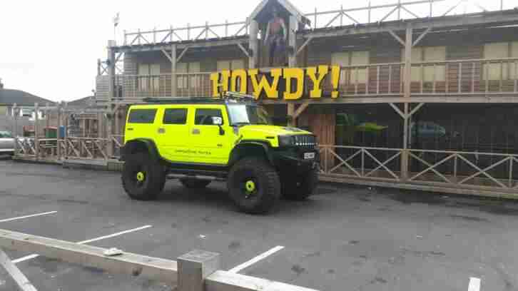 Hummer H2 LPG with lift kit. Day glow yellow. Light bars. Monster truck